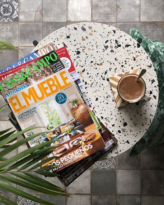 We love interior magazines! Round stone table with magazines.