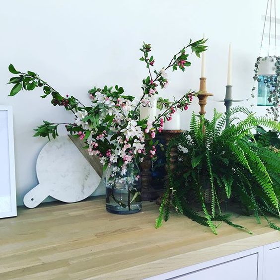 Styling foraged finds from a walk. Marble chopping board styled behind some blossom branches