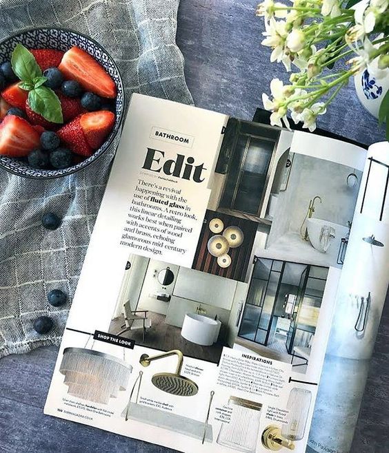 We love interiors magazines! Lifestyle flat lay of interior magazines and some strawberries.