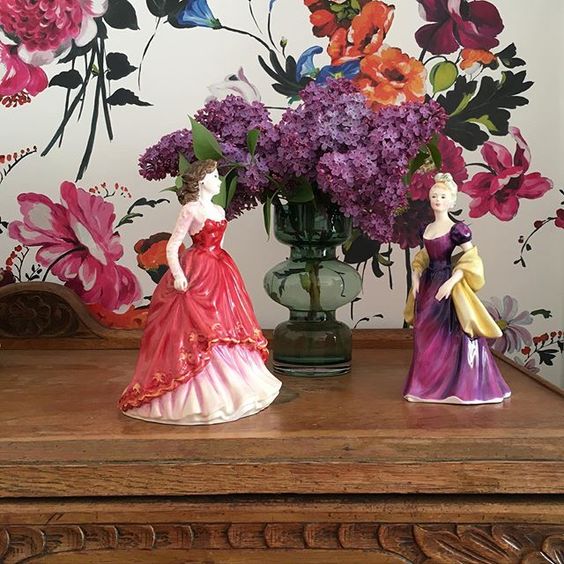 Styling foraged finds from a walk in your home. Fabulous purple flowers behind two female figurines