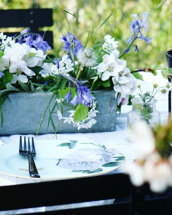 Styling foraged finds from a walk. Lifestyle image of a table setting with flowers.