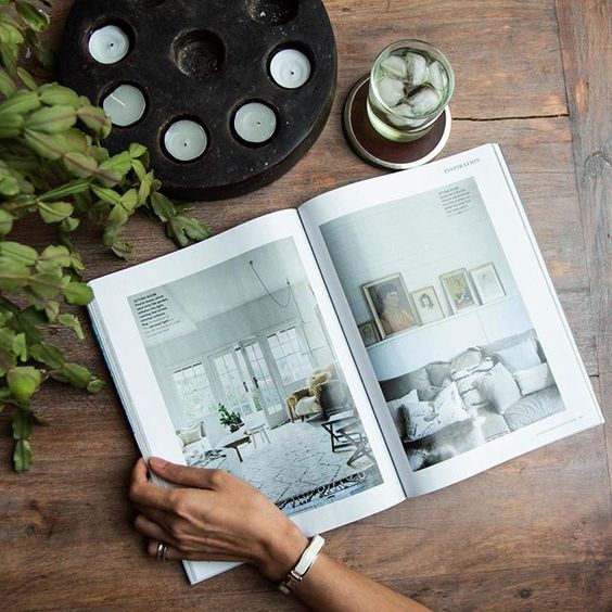 We love interior magazines! Flat lay of a magazine and glass of water.