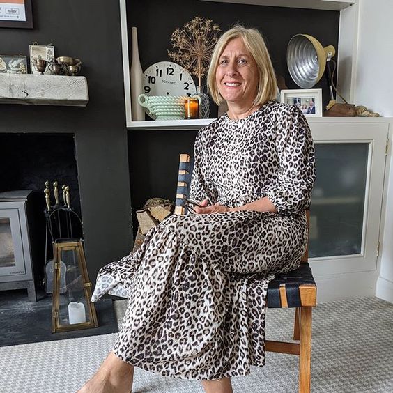 The top UK interior stylists you should be following. Picture of an elegant woman sitting on a chair