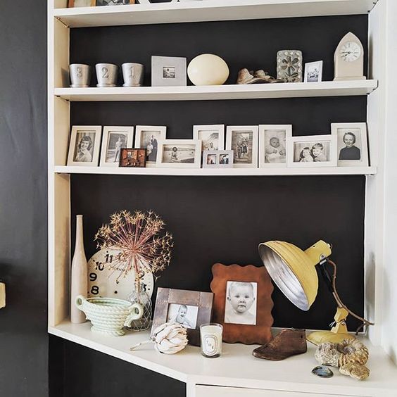 20 of the best vintage interiors in the UK. Styled white shelves with vintage photo frames