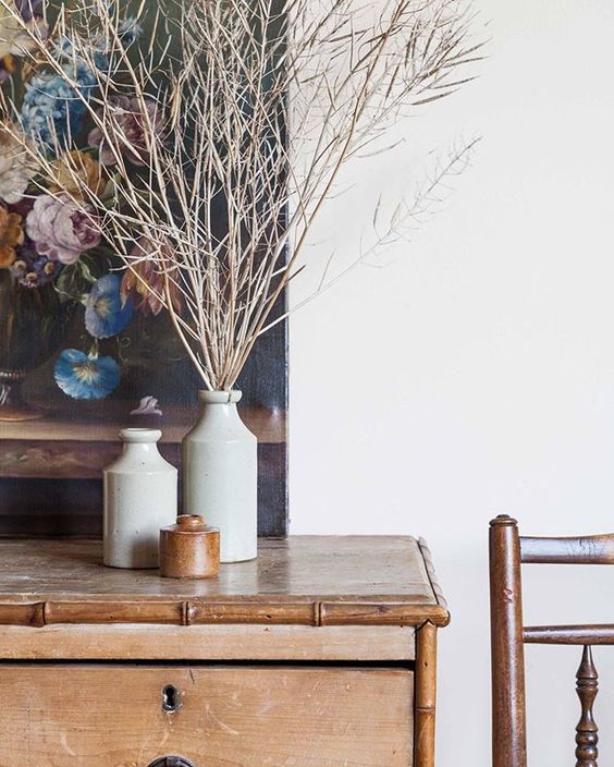 How to use colour in a room. Floral artwork styled behind 3 vases and styled branches