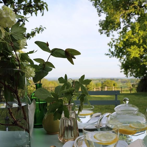 The secret styling tip for adding personality to your home that you need to know! Lifestyle shot of a table styled with drinks outside in the English countryside