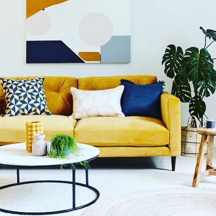 How to use colour in a room. Bright yellow sofa styled with colourful blue cushions