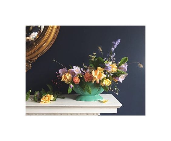 The secret styling tip for adding personality to your home that you need to know! Interiors vignette of a collection of colourful flowers on a mantlepiece