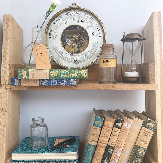 20 of the best vintage interiors in the UK. Vintage colourful books and a weather gauge on open shelving