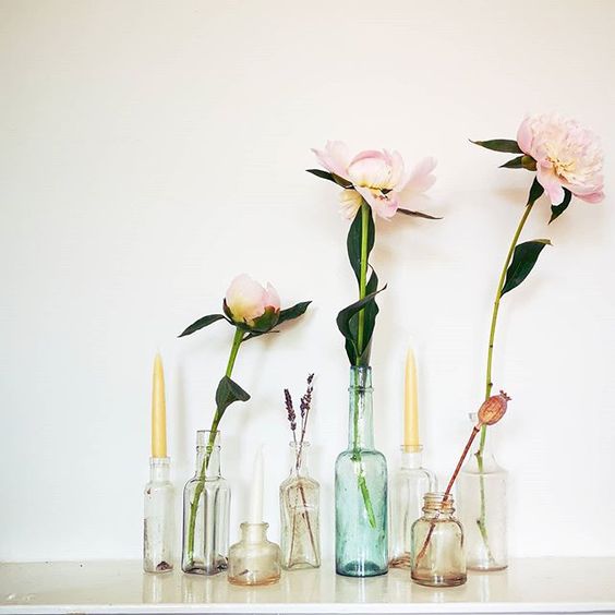 The secret styling tip for adding personality to your home that you need to know! Single stem flowers styled in coloured glass vases