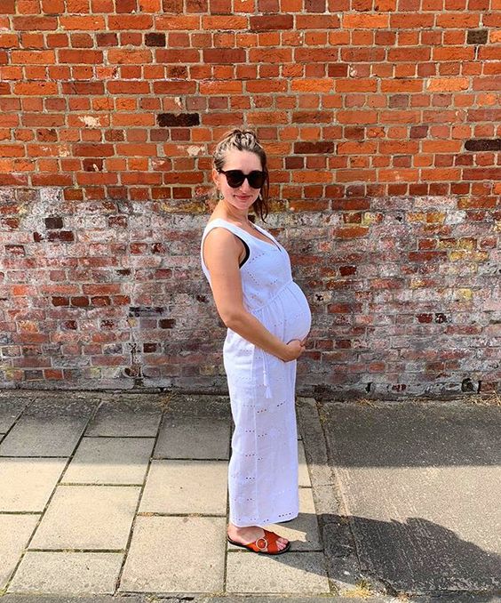 The top UK interior stylists you should be following. Picture of a pregnant woman cradling her bump