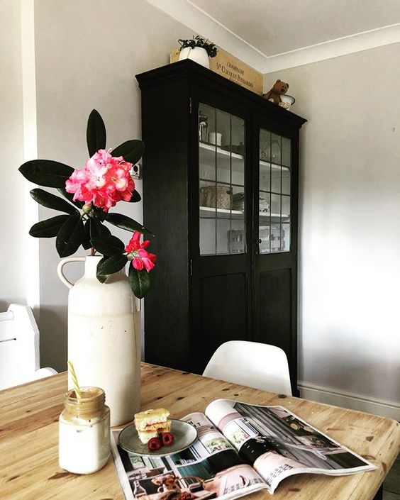 How to use colour in a room. Beautiful pink flowers styled in front of a black dresser