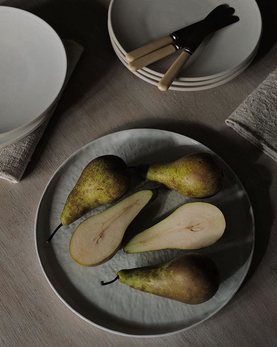 The secret styling tip for adding personality to your home that you need to know! Lifestyle flatlay of cut pears on a round plate