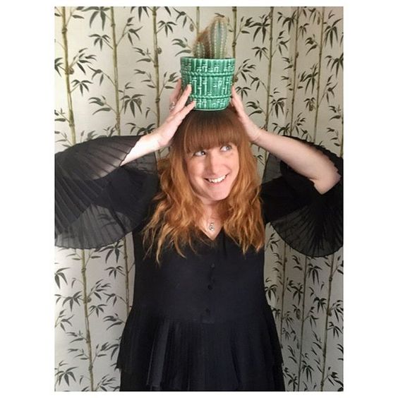 The top UK interior stylists you should be following. Quirky image of a red-headed woman with a green plant on her head