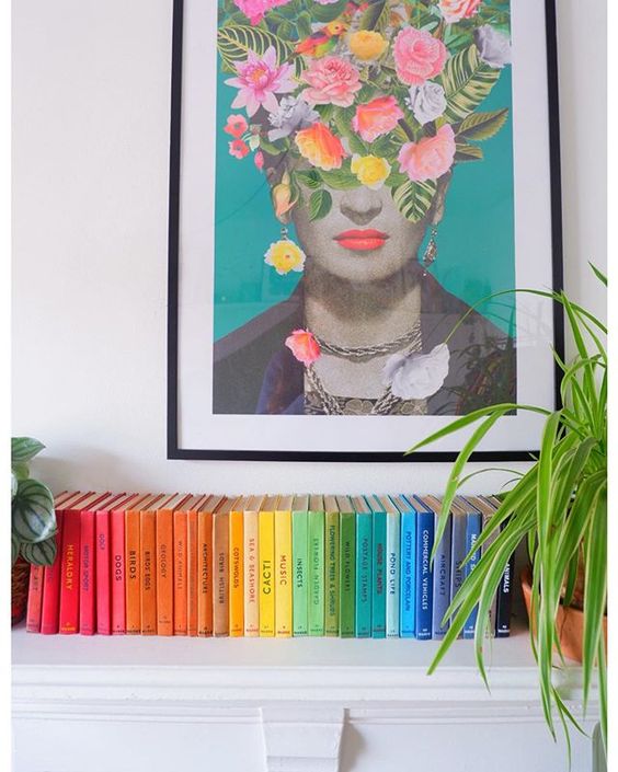 How to use colour in a room. Books organised by colour underneath a print of Frida Kahlo