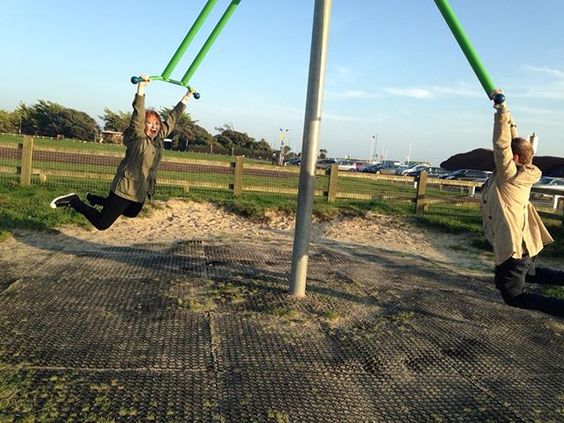 How to stay positive online in 2020. Man and a woman on a child's swing.