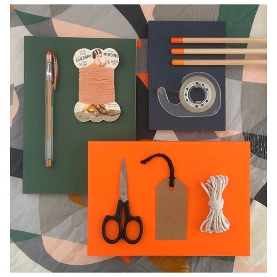 19 creative ways to use paper.Colourful lifestyle flat lay containing green and orange items, such as scissors, sellotape and matches.