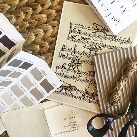 19 creative ways to use paper. Flat lay of paper products and paint swatches in muted tones.