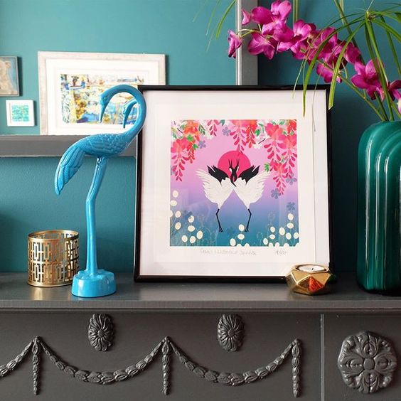 19 creative ways to use paper. Colourful framed print in front of a teal wall