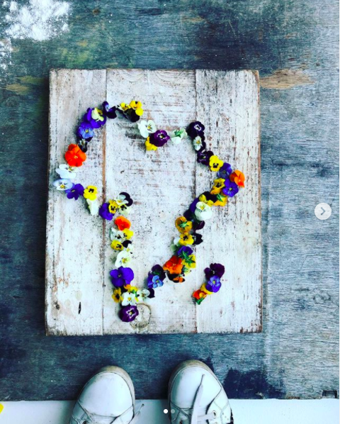 My happy place. Colourful petals in the shape of South Africa on a wooden plinth.