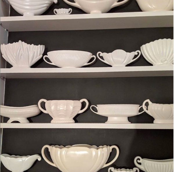 Shot of lots of white vases on shelves