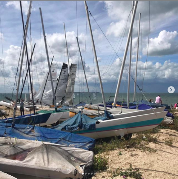 Sailing boats on Whitstable beach.