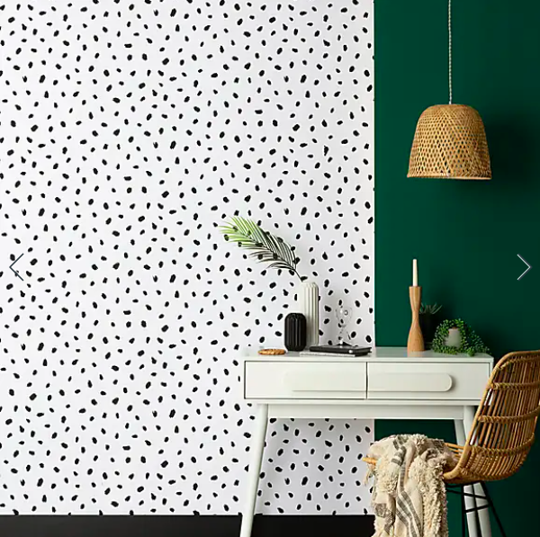 Black monochrome spot wallpaper in a home office with a desk and chair styled in front of it