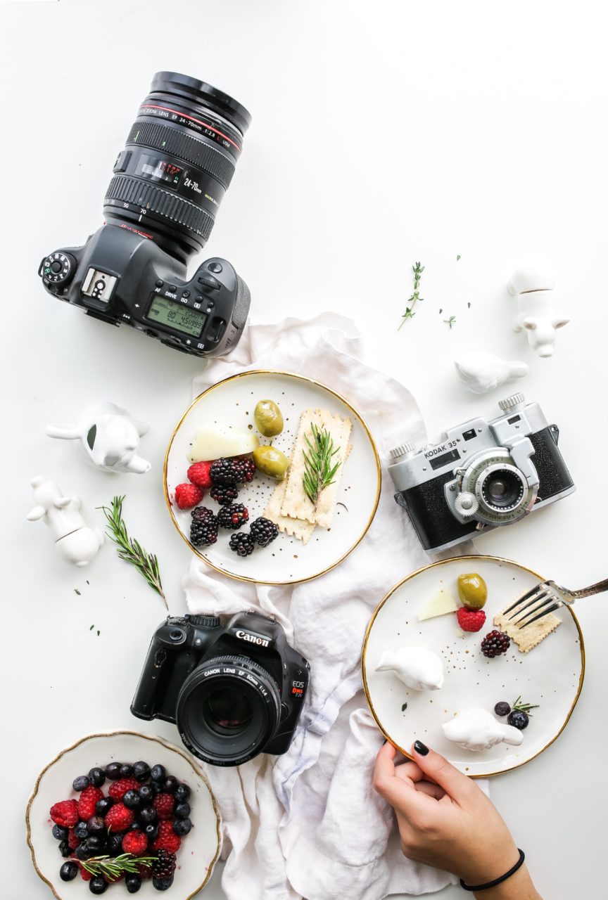 Flat lay of some cameras and food styling