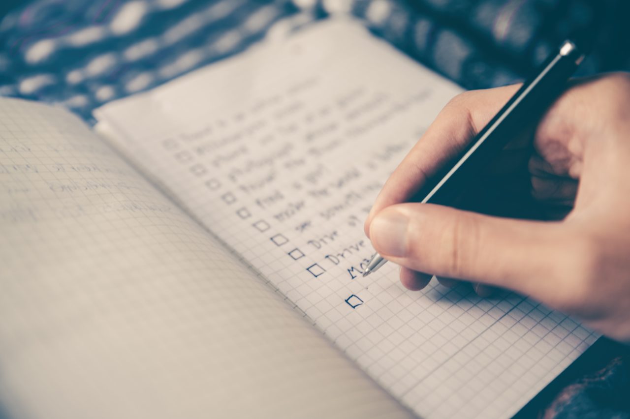 Photo of a handwritten checklist in a notebook