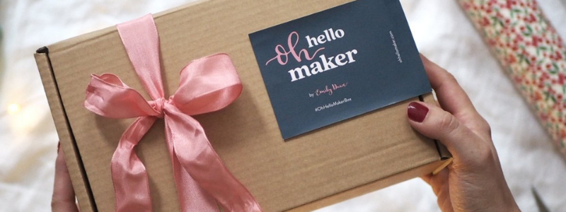 Brown kraft paper Gift box with a pink bow for a crafting gift subscription