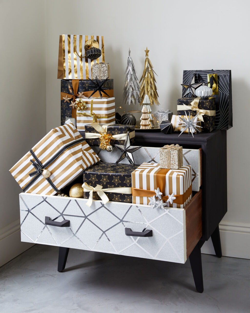 A chest of drawers with loads of Christmas gifts hidden inside 