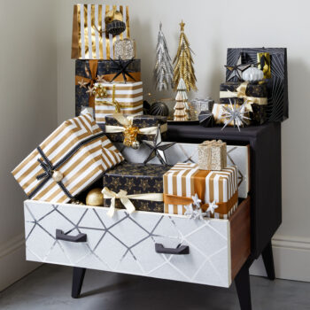 A chest of drawers with loads of Christmas gifts hidden inside