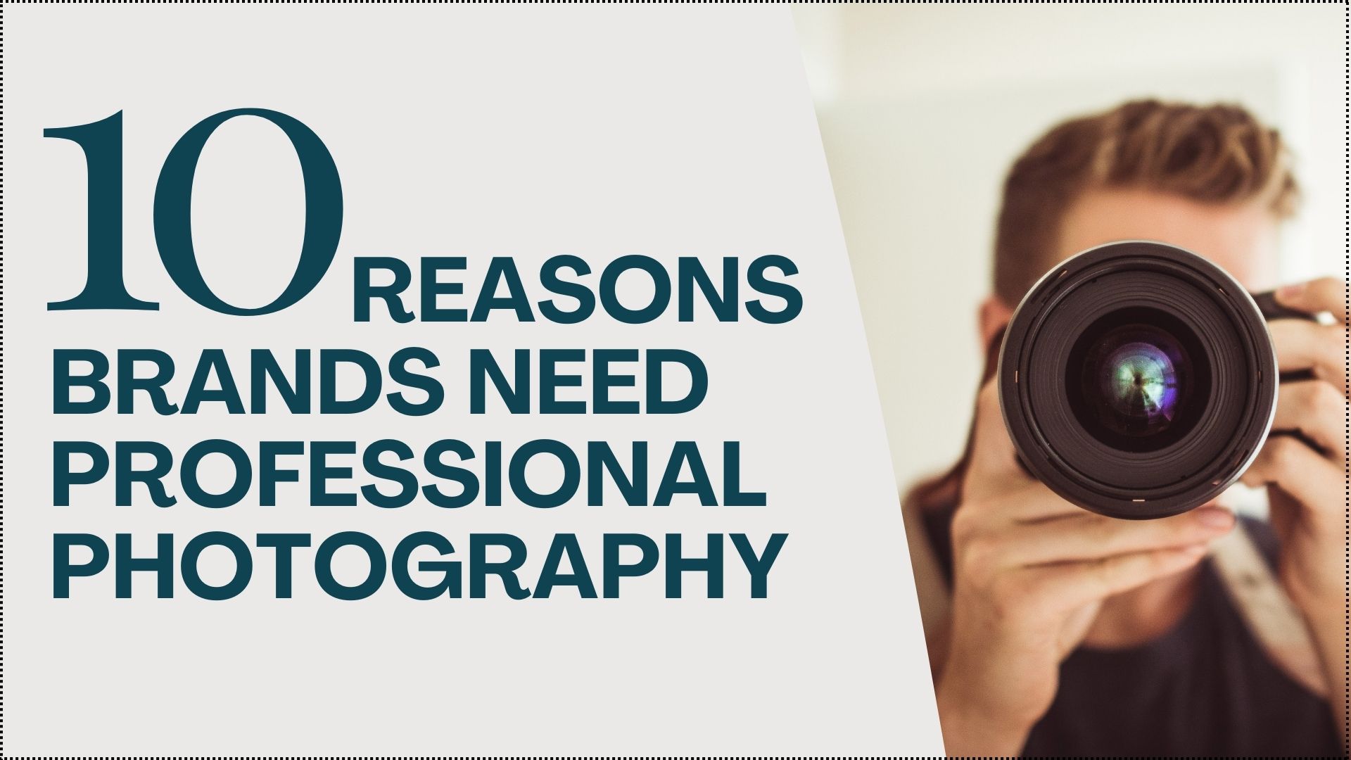 A male photographer holding a large DSLR camera with the lens in front and centre view 