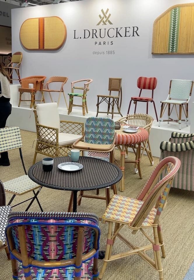 Colourful hand-caned rattan chairs by Maison Louis Drucker at Decorex 2026.